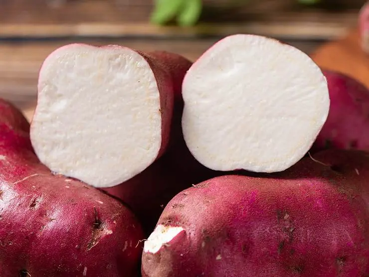 Fresh and raw sweet potatoes cut in half